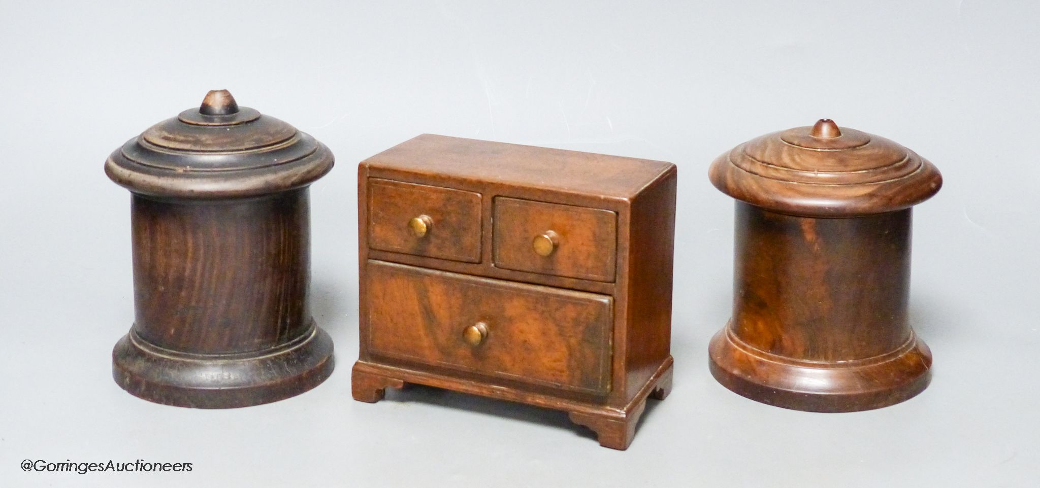 Two 19th-century Lignum vitae string boxes and a Georgian style walnut miniature chest of drawers, height 11.5cm width 13cm